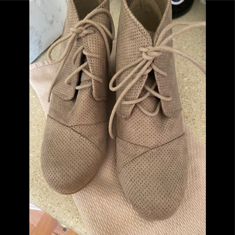 A pair of Light Tan Suede Wedge Short Boots